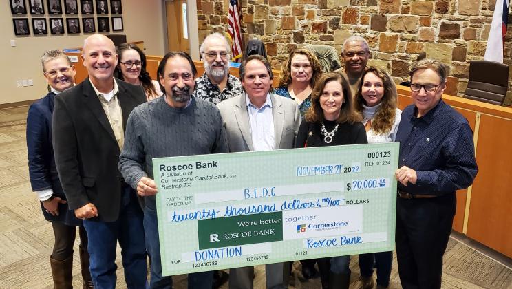 Representatives of Roscoe State Bank, including Executive Vice President Rick Womble (second from left), present a $20,000 check to the Bastrop Economic Development Corporation, including CEO Bret Gardella (front, center). Courtesy photo