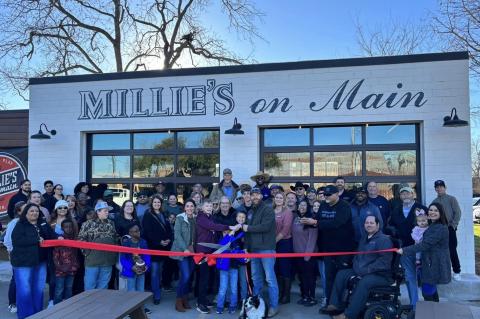 The Mauck family, with namesake family dog Millie, cutting their official ribbon. Photo courtesy Elgin Chamber of Commerce