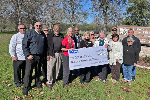 LCRA representatives present a $25,000 grant to Smithville officials for new signs at Vernon L. Richards Riverbend Park. The grant is part of LCRA’s Community Development Partnership Program. Pictured are, from left, Jack Page, Smithville director of public works and utilities; Robert Tamble, city manager; Brenda Page, Smithville Jamboree; Bill Gordon, city council member; Jill Strube, director of economic development and grants administration; Rick Arnic, LCRA Regional Affairs representative; Margaret D. “