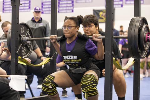 Ralyssa Enueshike squats at the regional powerlifting meet in Elgin March 4. Photo by Erin Anderson