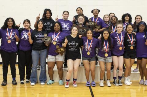 Elgin’s girls powerlifting team celebrates winning first at the regional meet in Elgin March 4. Photo by Erin Anderson