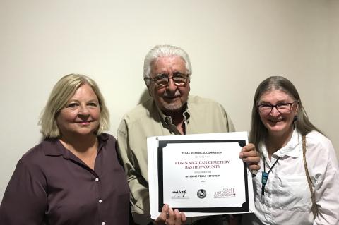 Pictured are members of the community team — Donna Snowden, former Bastrop County Commissioner, Debbie Wahrmund, Bastrop County Historical Commission, and Juan Gonzalez, Elgin Mexican Cemetery Association — holding the certificate in regards to the Elgin Mexican Cemetery’s designation as a Historical Texas Cemetery by the Texas Historical Commission.   Courtesy photo