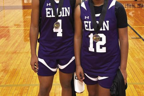 Elgin High School girls varsity basketball senior Jaylan Roberson (left) and sophomore teammate Trinity Martinez (right) happily pose together Nov. 18 at the Crockett Tournament in Austin after being selected to the all-tournament team. Photo courtesy of Elgin ISD