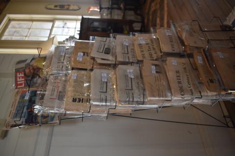 Items being sold at McDade Antiques and Marketplace in McDade include old newspapers, seen here on display during the grand opening April 1. Photo by Fernando Castro