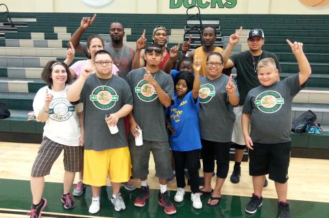 The members of team Flight celebrate with the Shining Stars after the 3-on-3 basketball tournament in 2016.     Photo by Jason Hennington