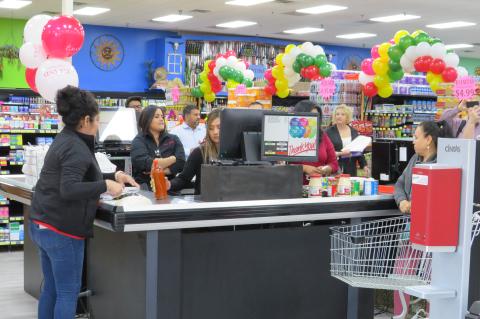 Customers buy some of the first products purchased at Poco Loco Supermercado’s Elgin location Sept. 29. Photo by Fernando Castro