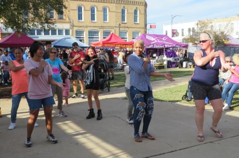 Residents dance to the Macarena during the Hogeye Festival in downtown Elgin Oct. 22. Photo by Fernando Castro