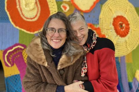 Monica Poss (left) and Kim Iberg stand in front of the Smithville Yarn Bombers’ latest project. Poss was the project organizer and main taskmaster, and Iberg was designer. Courtesy photo