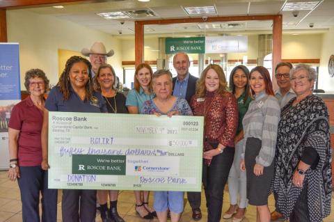 Representatives of Roscoe State Bank present a check of $50,000 to the Bastrop County Long Term Recovery Team in a recent gathering.   Courtesy photo