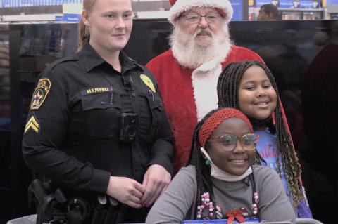 Elgin police officer Mary Majefski and Santa Claus prepare to help children shop for toys Dec. 18, 2021. Photo by Julianne Hodges