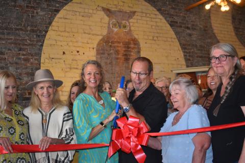 Molly Alexander, Gary Luedecke and staff members celebrate The Owl’s 10-year anniversary with a ribbon cutting ceremony.   Photo by Quinn Donoghue