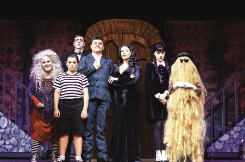 The cast of Addams Family, The Musical, in their iconic garb: Kelsey Layton, Benjamin Walk, Chase Lancaster, Jacob Layton, Aline Forastieri, Shiloh Bartee and Phoebe Bartee.