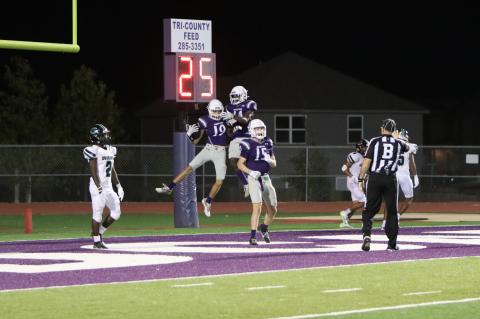 Elgin High School varsity football senior wide receiver Blake Courtney (19) celebrates with sophomore wide receiver Gary Jefferson Jr. (14) and junior wide receiver Blake Thames (15) following a touchdown on Sept. 22 during the Wildcats’ 50-28 victory at home vs. Pflugerville Connally High School. Photo by Zoe Grames