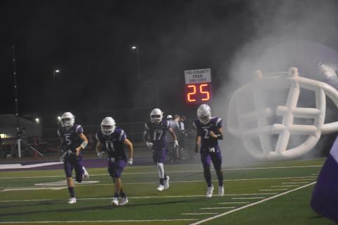 Wildcats players storm onto the field, ready for battle in the second half.  Photo by Quinn Donoghue