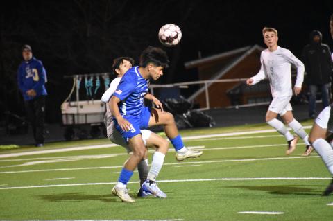 Manny Carreno Medina fights for position before heading the ball to one of his teammates. Photo by Quinn Donoghue