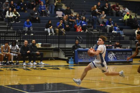 Kole Masters goes the length of the court for a fast break layup. Photo by Quinn Donoghue