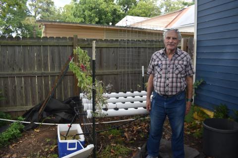 Norman Jones presenting one of his hydroponic models at his nephew’s house in Smithville.  Photo by Quinn Donoghue