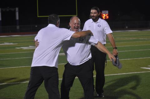 Head football coach Heath Clawson celebrates after their opening game win against Lampasas, marking their first victory since November of 2020.