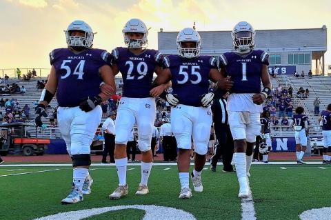 The Elgin High School varsity football captains take the field on Sept. 1 prior to the Wildcats’ home game vs. Austin Akins High School. From left to right: senior Hunter Gibson, junior Jackson Clowdus, senior Dennis Lavigne and senior Nathen Lewis. Photo by Marcial Guajardo 