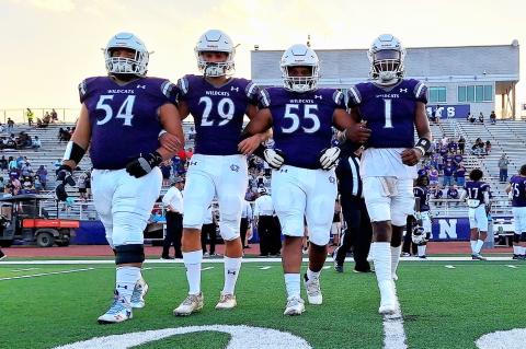 The Elgin High School varsity football captains take the field Sept. 1 prior to the Wildcats’ home game vs. Austin Akins High School. From left to right: senior Hunter Gibson, junior Jackson Clowdus, senior Dennis Lavigne and senior Nathen Lewis. Photo by Marcial Guajardo