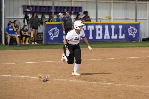 Paiton Altmiller taking off to first base after smacking a ball into the outfield. Photo by Erin Anderson