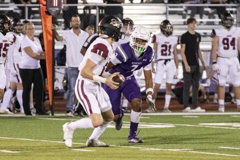Elgin defensive end Derrius Holiday doing what he does best: rushing the passer and being a quarterback’s worst nightmare. Photo by Erin Anderson
