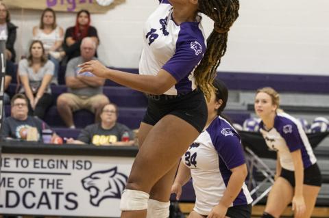 Josephine Jackson prepares to deliver a powerful spike for the Wildcats.  Photo by Erin Anderson.