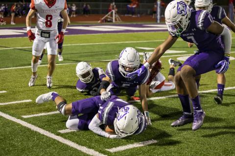 Isaias Galarza diving on the ball for a fumble recovery after Justin Strong punched it loose. Photo by Erin Anderson
