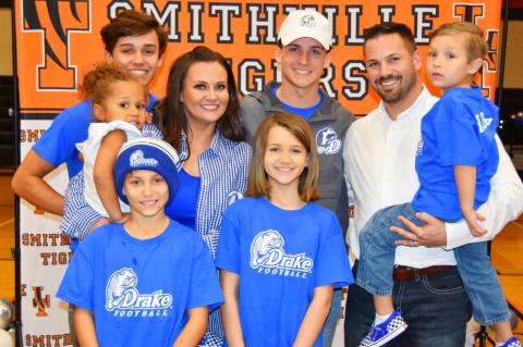 Tyson Hancock (middle) celebrates his official announcement to play for Drake University with family members. Photo courtesy of Lindsey Saunders.