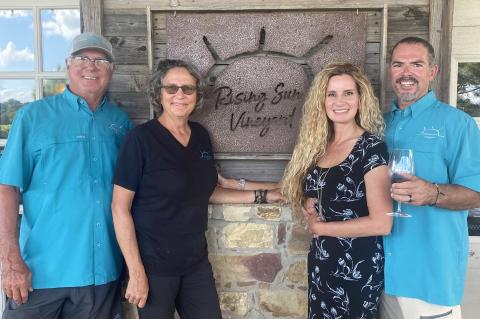 Steve and Sandy Frintz (left) enjoy a peaceful afternoon at the vineyard with their kids Bart and Tiffany. Photo courtesy of Rising Sun Vineyard.