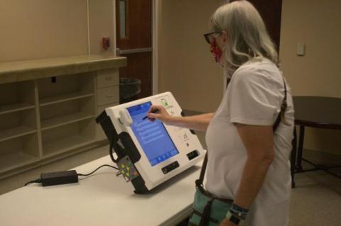 Leslie Landreth selects from a list of choices on the ballot-marking machine in this 2020 photo. Photo by Julianne Hodges
