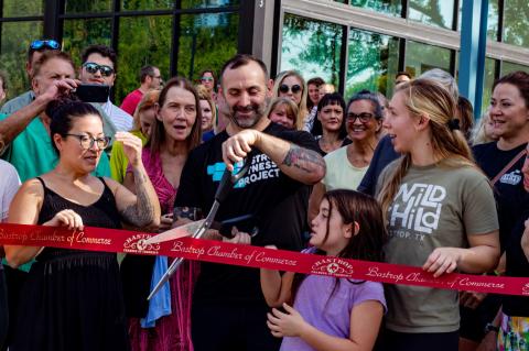 Owner Athan Schindler cuts the ribbon to celebrate the grand opening of Bastrop Fitness Project along with local residents. Photo courtesy of Bastrop Chamber of Commerce