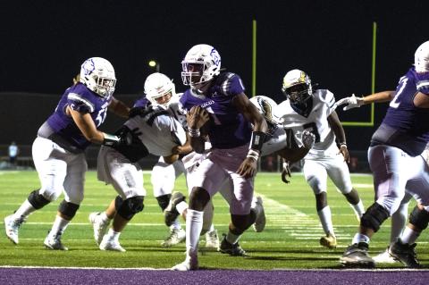 Elgin High School varsity football senior quarterback Nathen Lewis follows blocks from his offensive line and scores a rushing touchdown Sept. 1 during the Wildcats’ dominant 47-0 home victory versus Austin Akins High School. Photo by Marcial Guajardo
