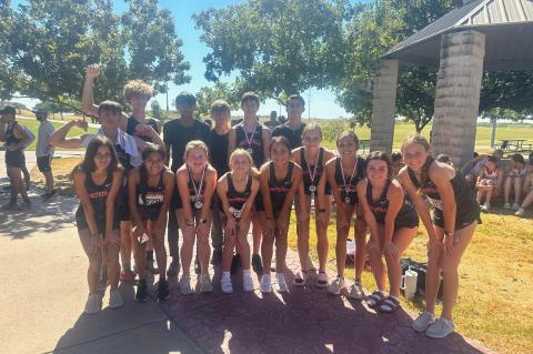 The Smithville High School varsity cross country squad happily gathers for a team photo on Sept. 8 following the Tigers and Lady Tigers competing in the Pflugerville Invitational. Photo courtesy of Smithville Lady Tiger Athletics