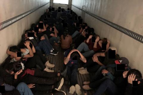 Eighty-one migrants sit in the back of a tractor trailer in this undated photo from the U.S. Department of Justice. Courtesy photo