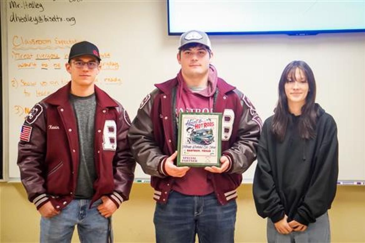 Clayton Sherman, Kevin Hoefer and Laina McDonald receive a plaque from the Bastrop Area Cruisers Feb. 3 in Bastrop for volunteer work. Courtesy photo
