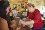 Melba Skubiata helps a customer at McDade Antiques and Marketplace in McDade April 1. Photo by Fernando Castro