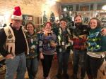 Amy Miller (second from left), Elgin community development director, and others dress up in their holiday sweaters in Elgin. Courtesy photo