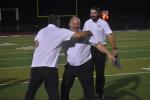 Head coach Heath Clawson celebrating Elgin’s opening night victory with his coaching staff.  Photo by Quinn Donoghue